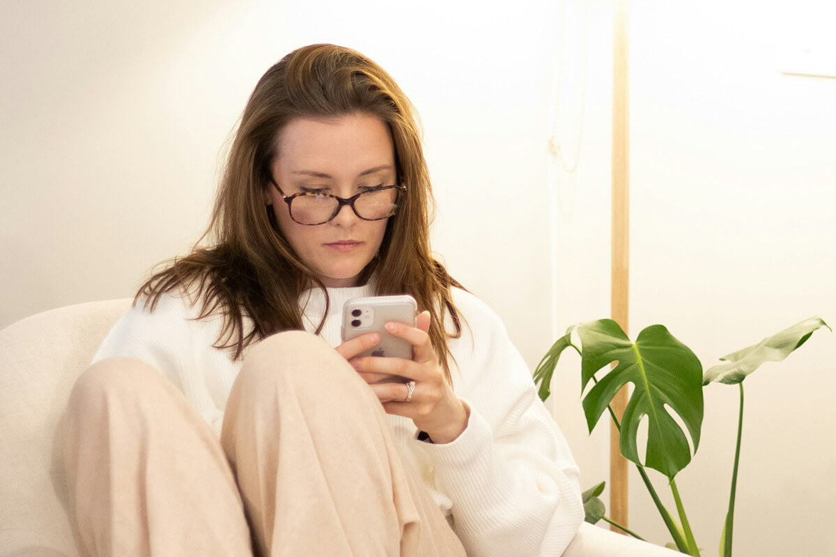 A woman booking an telemedicine appointment on her phone
