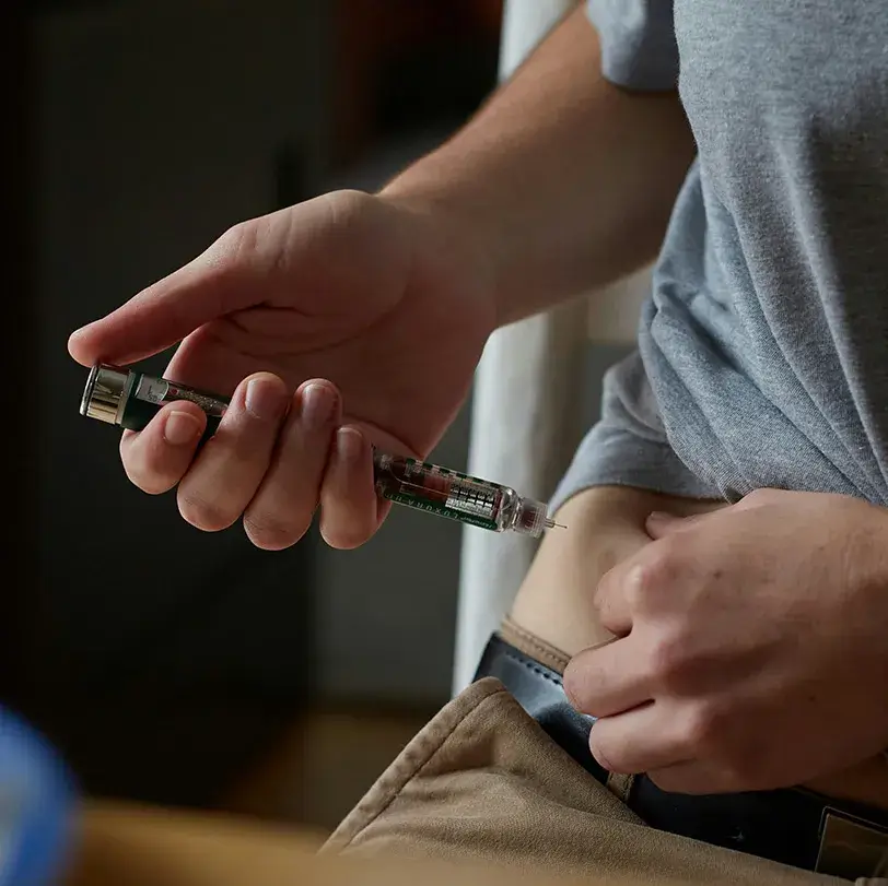 Person injecting GLP-1 into side