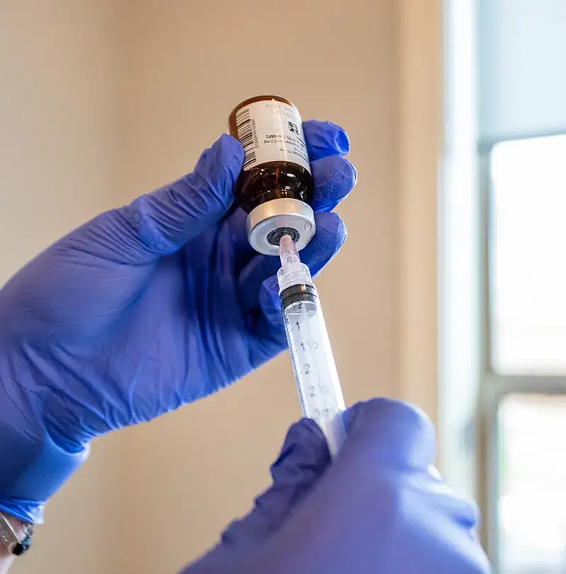 A nurse preparing an NAD Oklahoma injection