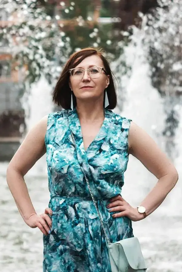 Confident woman standing near fountain